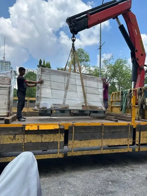 Residents helping to transport large tiles